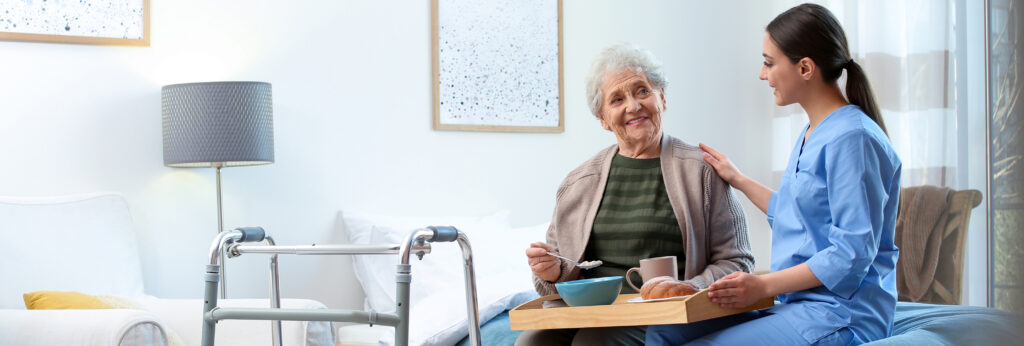A woman offers assistance as a hospice care at home professional.