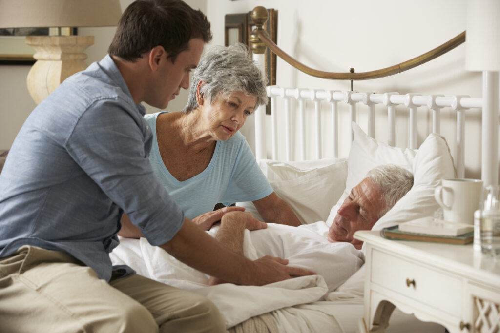 Old men being cared by a doctor in a hospice