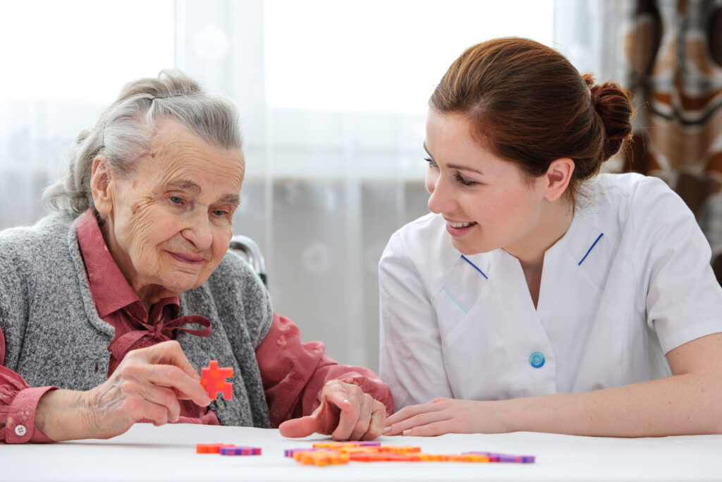 Old women with Dementia being cared by a nurse in a hospice.