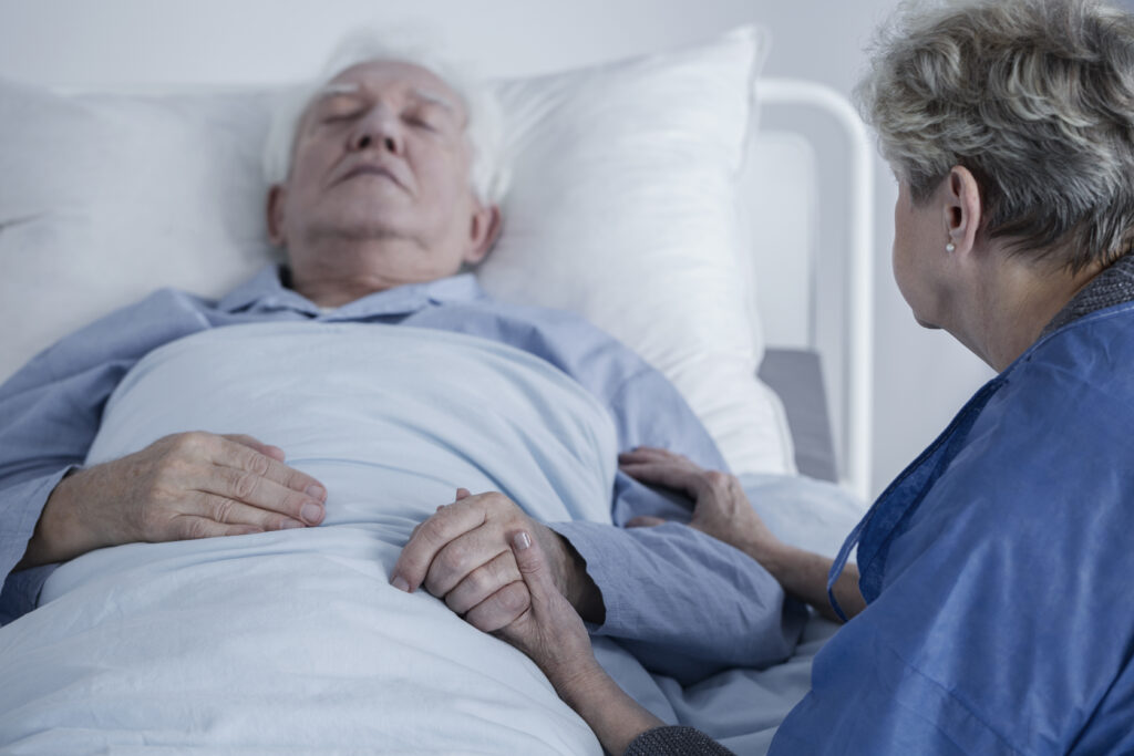 Old palliative patient with his family in a hospice