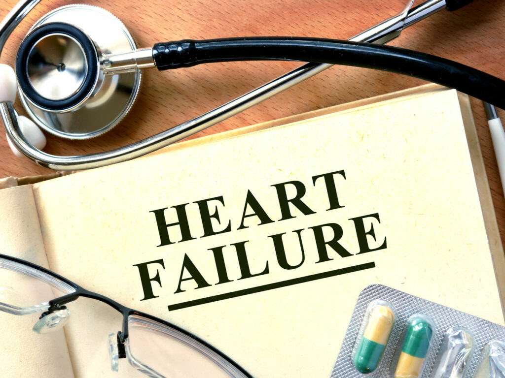 Cardiology Insights: A photograph captures a cardiologist's desk with a Heart Failure book, stethoscope, reading glasses, and medication packet. A glimpse into the world of heart health and expertise.