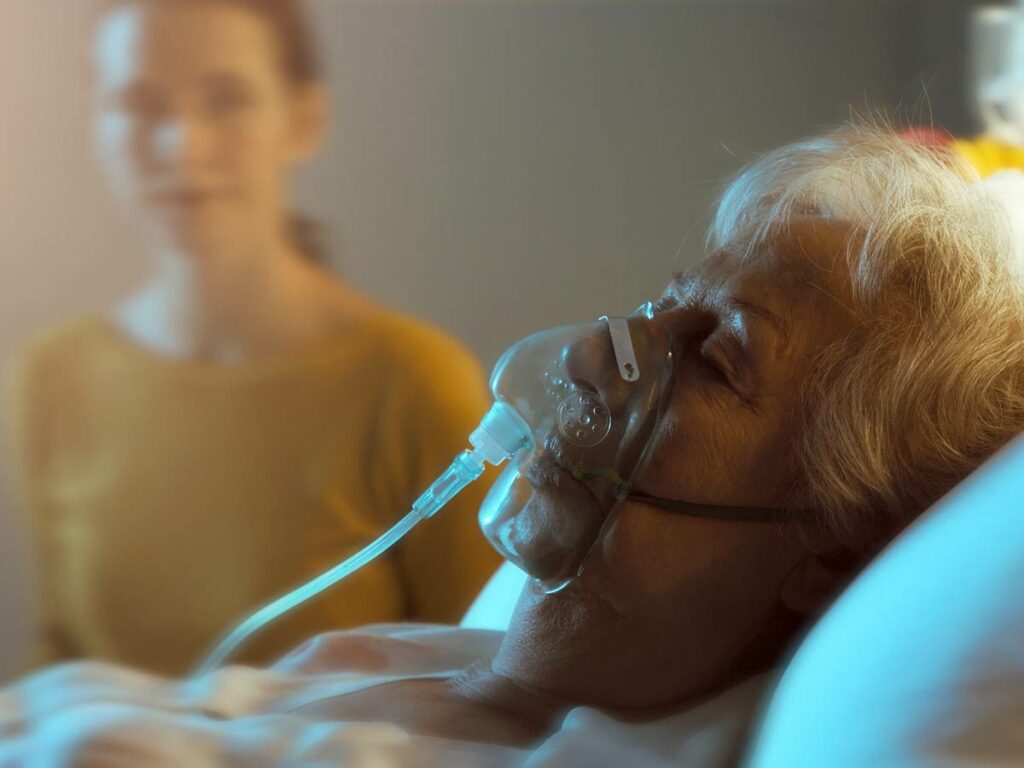 Caring for COPD in Hospice: An emotional image of a patient and caretaker, showcasing the vital role of oxygen therapy in end-of-life care.