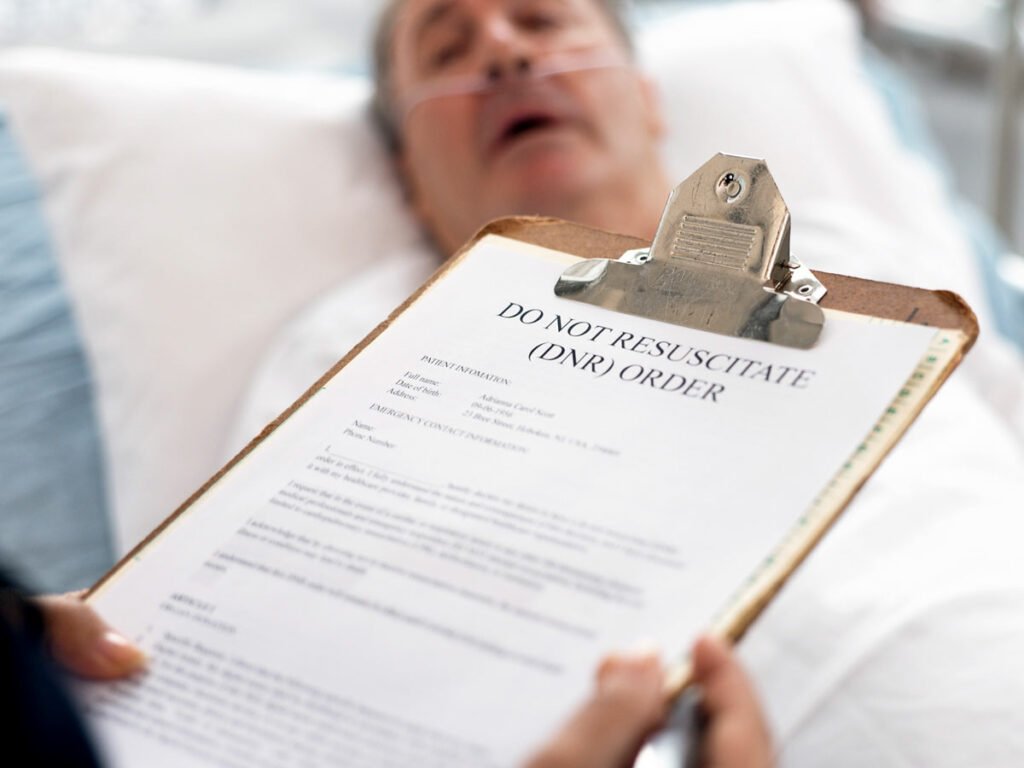 "Compassionate Care: A hospice social worker holds a clipboard with a do-not-resuscitate (DNR) form, standing by the bedside of a hospice patient. This poignant image encapsulates the delicate support and decision-making that surrounds end-of-life care."