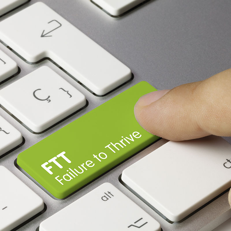 Illustration of a green keyboard key labeled 'FTT - Failure to Thrive,' symbolizing declining health indicators in adults who are nearing death.