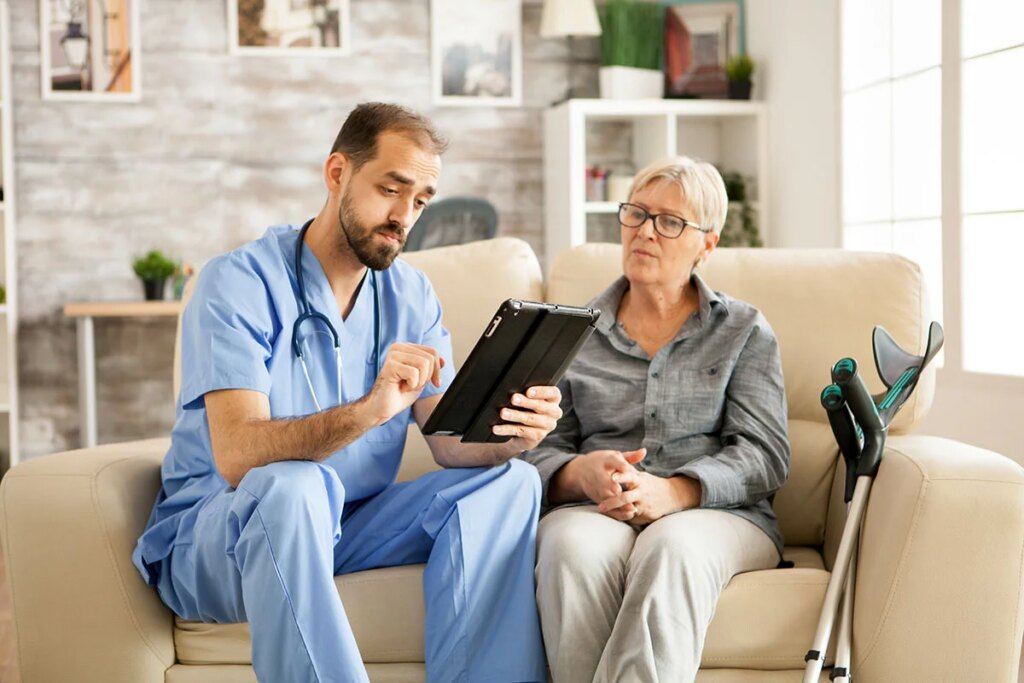 Hospice Nurse reviewing comfort care options with a patient in her home.