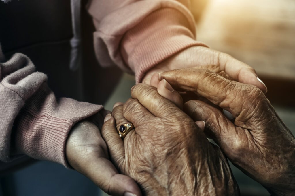 A compassionate hospice volunteer offers solace to a patient in need.